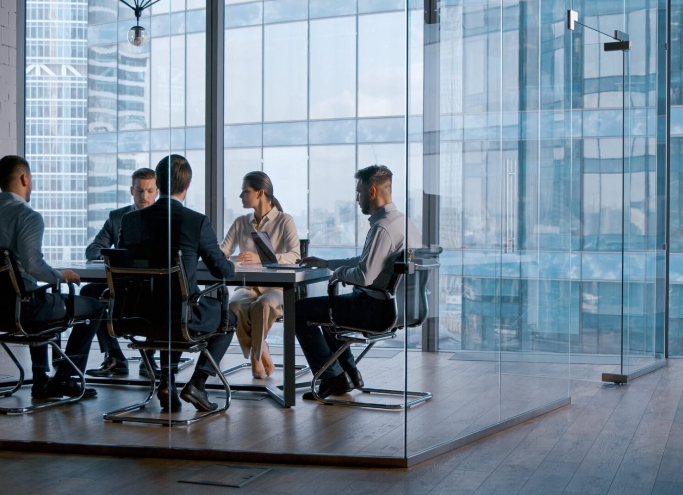 Young business people attending the meeting in boardroom
